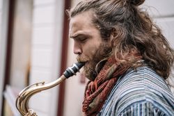 Male saxophonist plays Sax in the street