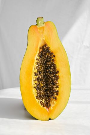 Half of papaya fruit placed on table in studio