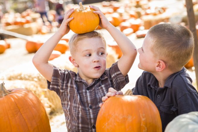 Two Boys at the Pumpkin Patch Talking and Having Fun.