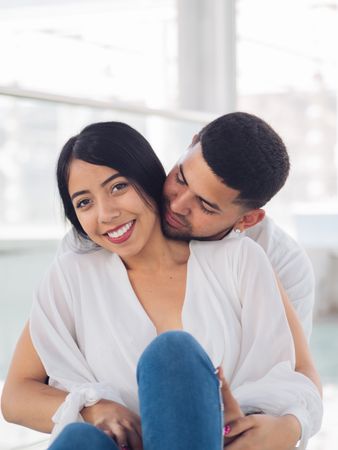 Man embracing smiling woman with love and tenderness