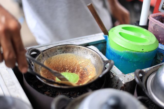 Seller Cooking Kue Ape Pandan, Traditional Thin Pancake Popular as Street Food in Indonesia