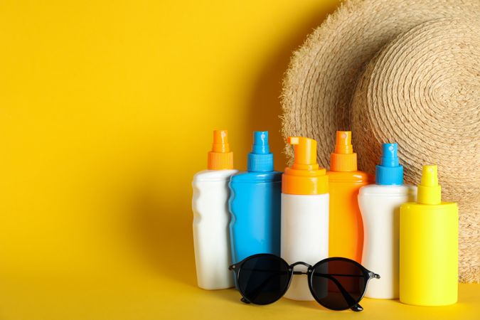 Summer vacation accessories on color background, space for text. Safe tan