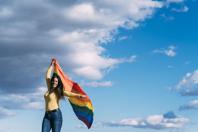 Young woman with rainbow gay pride flag