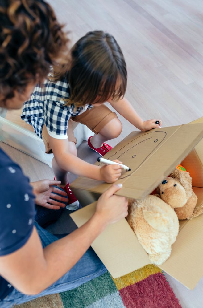 Boy drawing in a moving box