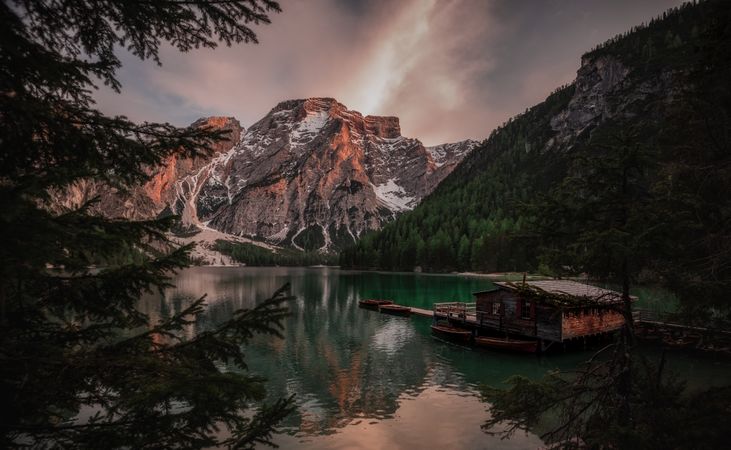 Houseboat surrounded with mountains on serene lake