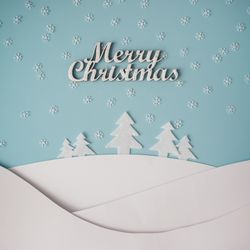 Christmas winter landscape with snowy hills and trees, with the words “Merry Christmas”