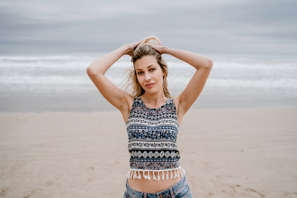 Happy female posing on sandy beach