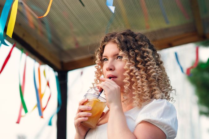 Woman with drink outdoors