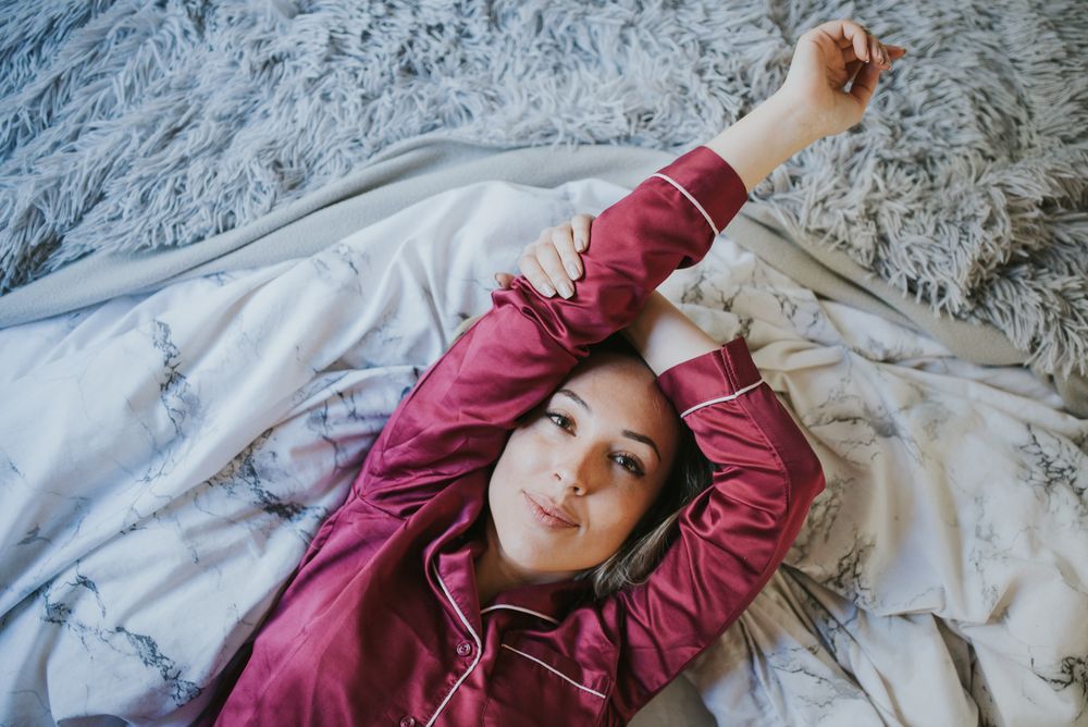 Woman and smiling in bed