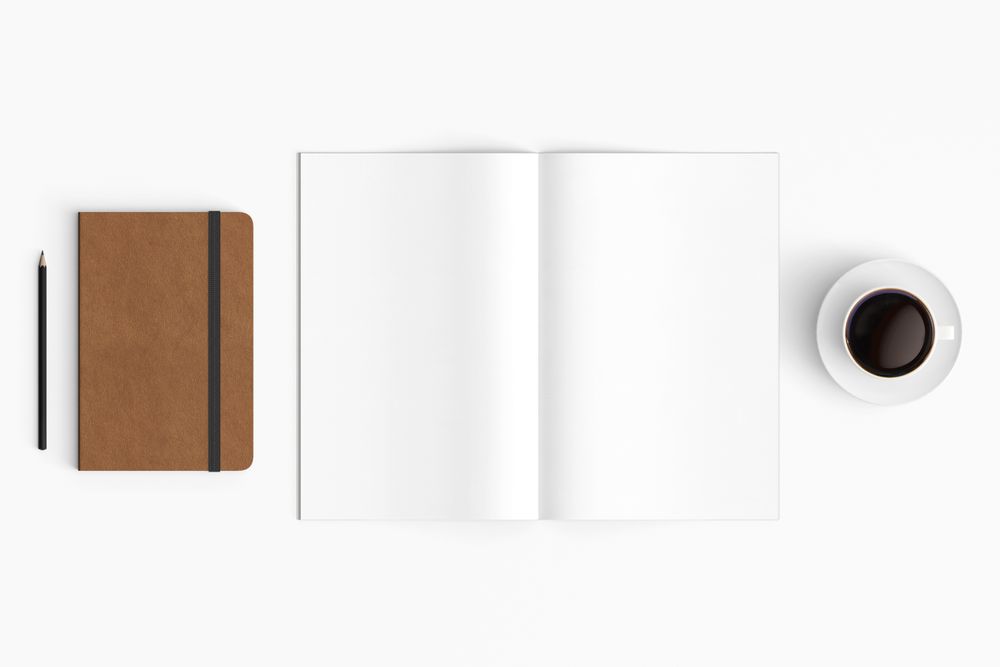 Modern workspace with coffee cup, smartphone, paper, notebook