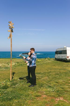 Young couple looking a map and direction sign