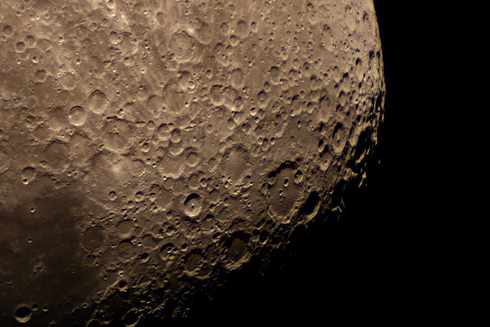 Magnified crater region revealing scattered lunar pits and ridges