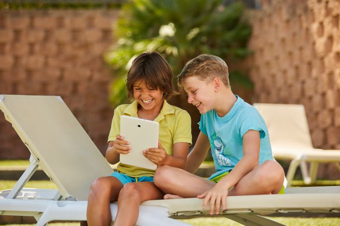 Boys using tablet in garden