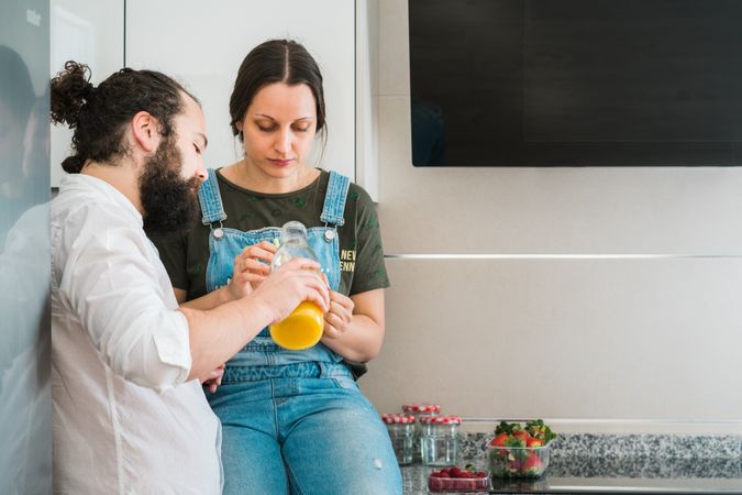 Couple eating healthy food in kitchen