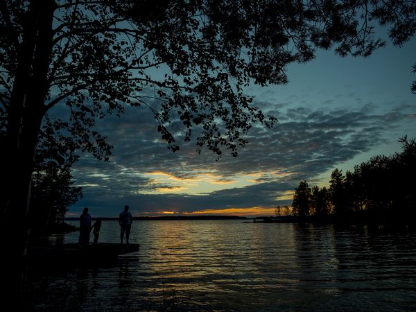 People in a beautiful sunset landscape in Finland