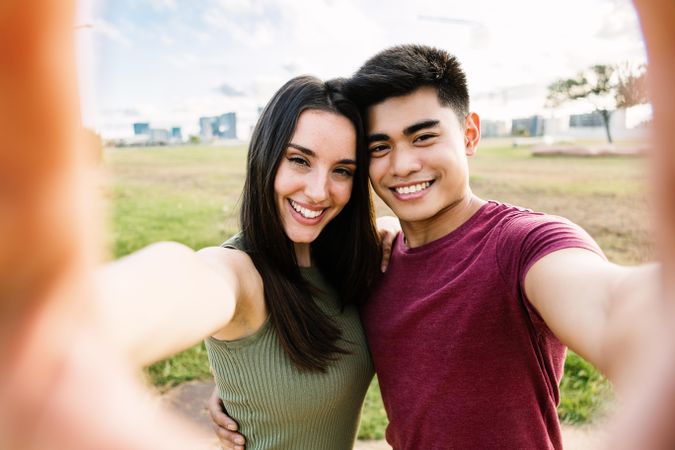 Young couple taking selfie together outdoors during vacation