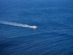 White yacht sailing in blue sea