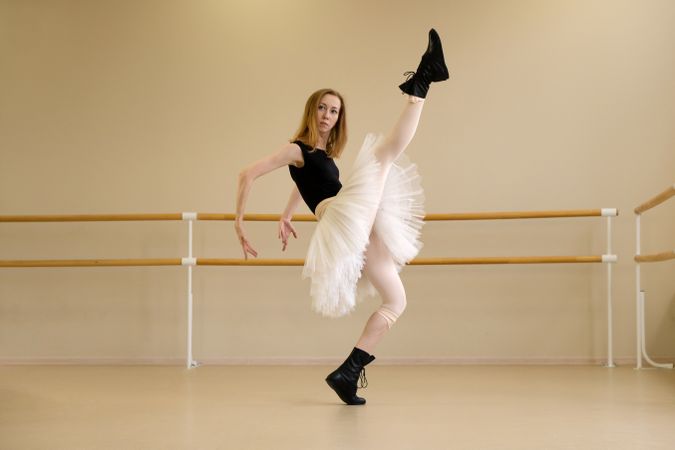 Ballerina in shoes and tutu, high leg kick