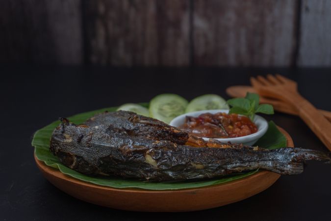 Fried catfish (pecel lele) with spicy sambal and basil leaves