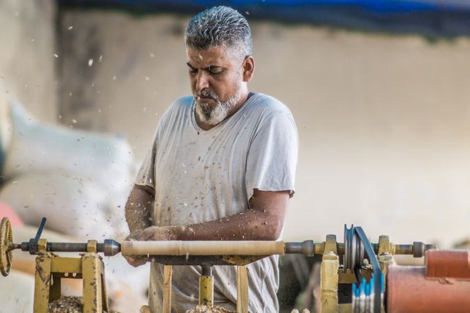 Man using woodworking machine at workplace