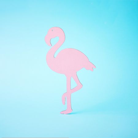 Pink flamingo shape on bright blue background