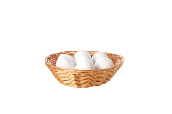 eggs in a round basket, isolated on blank background.