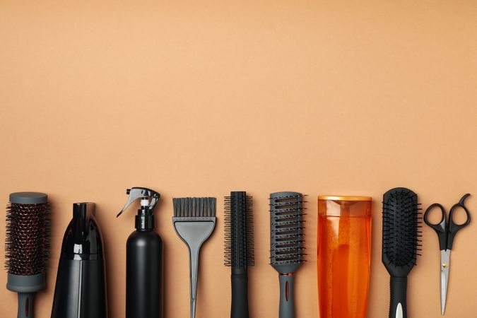 Composition with hairdresser accessories on beige background