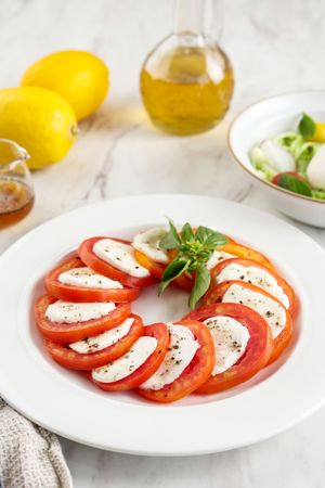 Salad Caprese with Sliced Red tomato, Mozzarella, and Basil