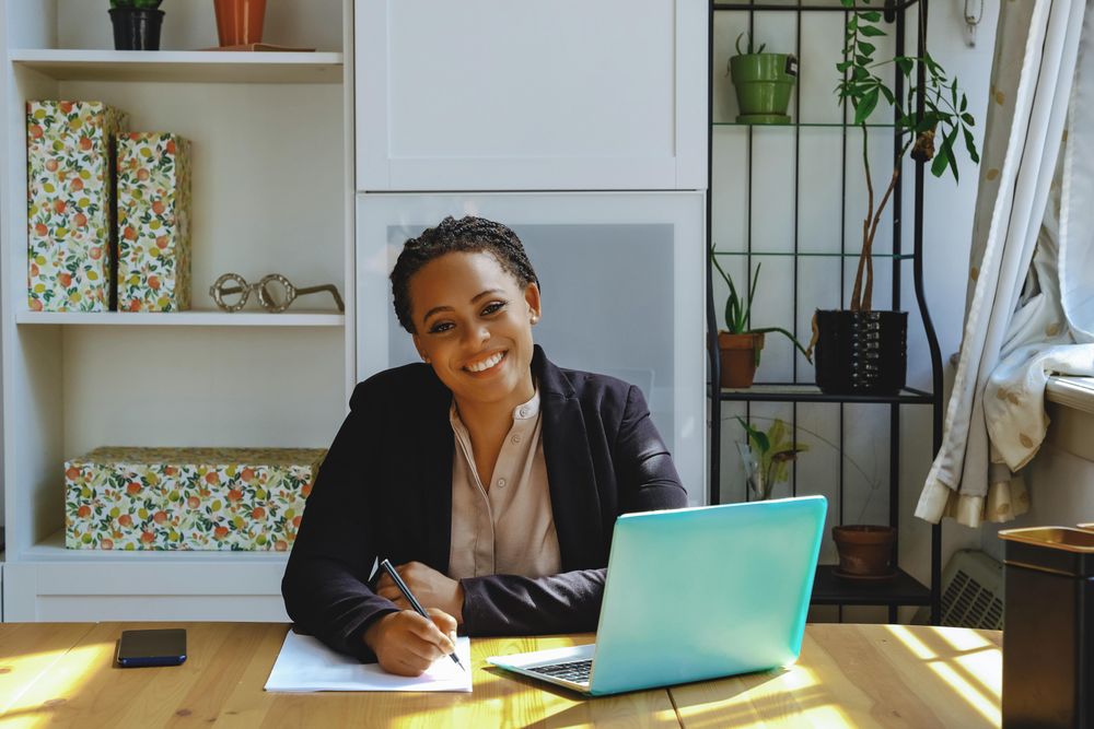 Content business owner taking video call on her laptop in her home office