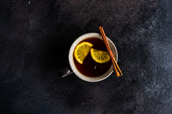 Top view of star anise and cinnamon balancing on tea cup