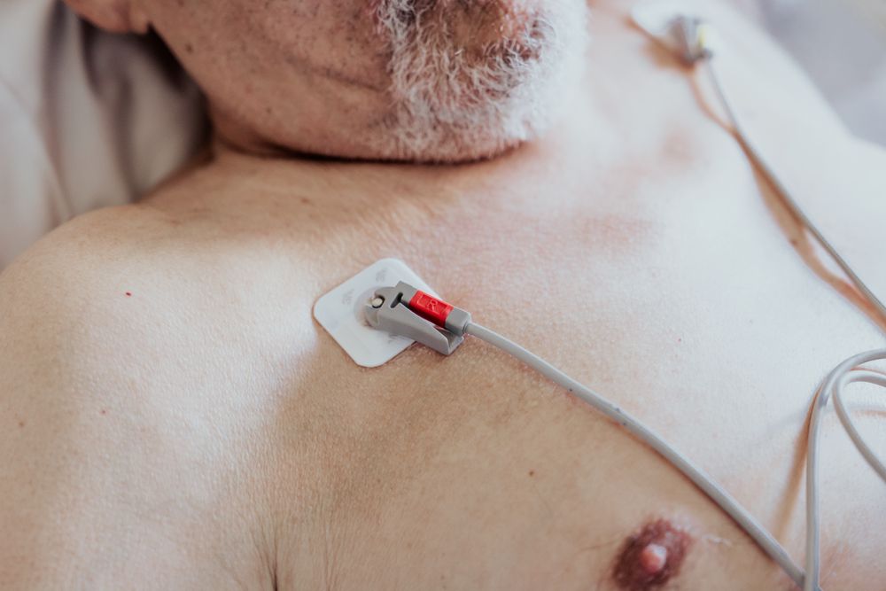 Older man admitted to a hospital room.