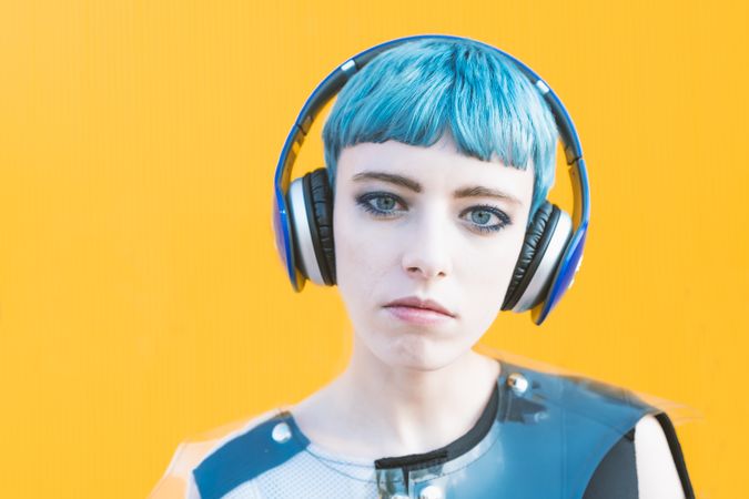 Cool informal woman in headphones on street