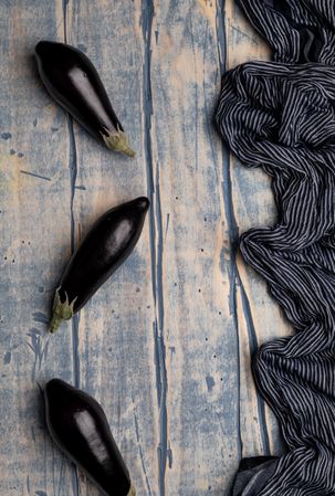 Ripe eggplants on shabby tabletop