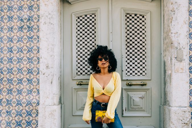 Fashionable Black female by gray door