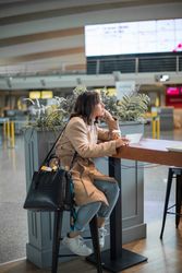 Female sitting and using smartphone at airport