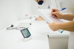 Crop pharmacist taking notes while controlling temperature and humidity in lab