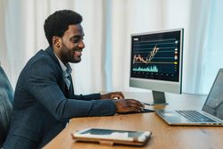 Black man working with binary option