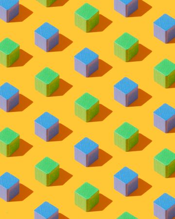 Blue and green cubes on yellow background