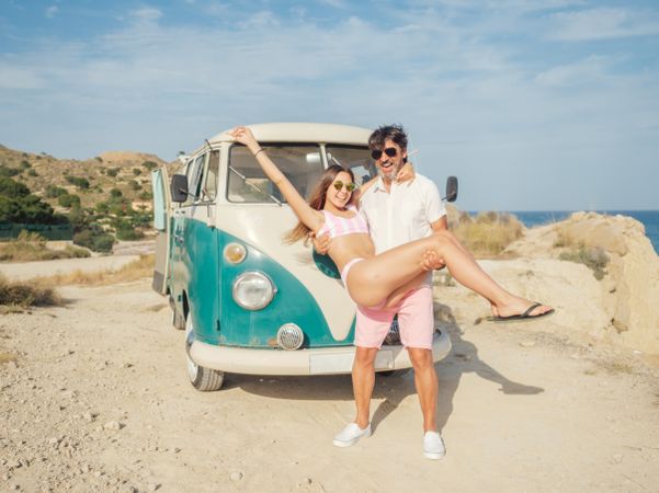 Man holding woman in hands and smiling
