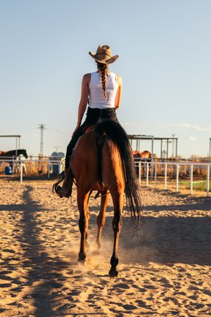 Woman riding a horse in an equestrian center