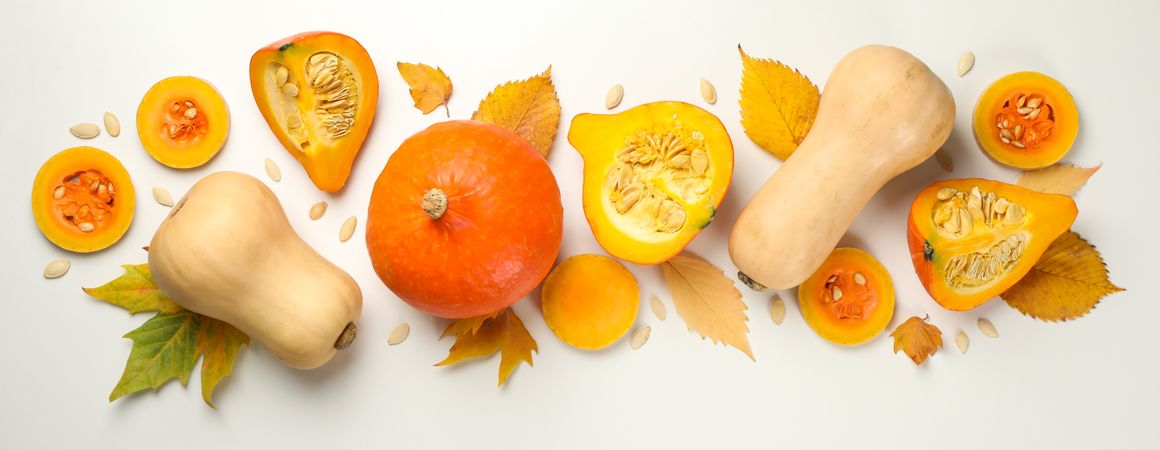 Composition with pumpkin, seeds and leaves on blank background