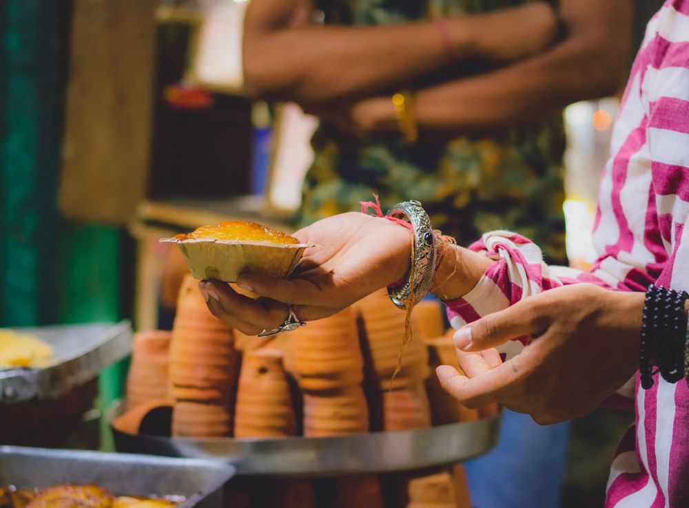 Cropped image of a person holding a saucer with food