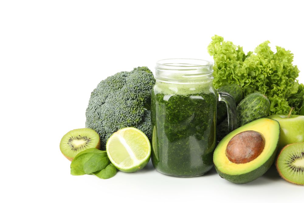 Green vegetables, fruits and jar of smoothie isolated on neutral background