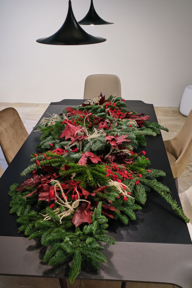 Christmas floral composition of spruce branches and red leaves