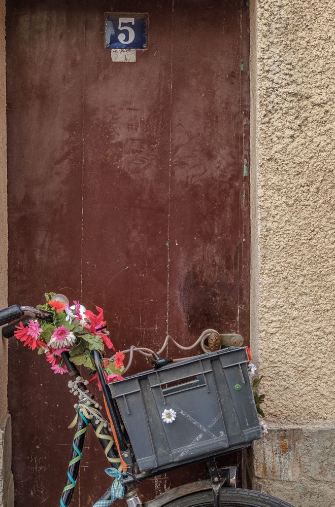 Plastic basket attached to decorative bike, vertical