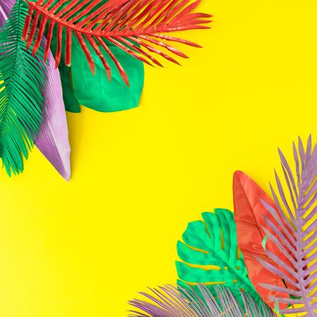 Painted tropical and palm leaves in vibrant bold colors on yellow background