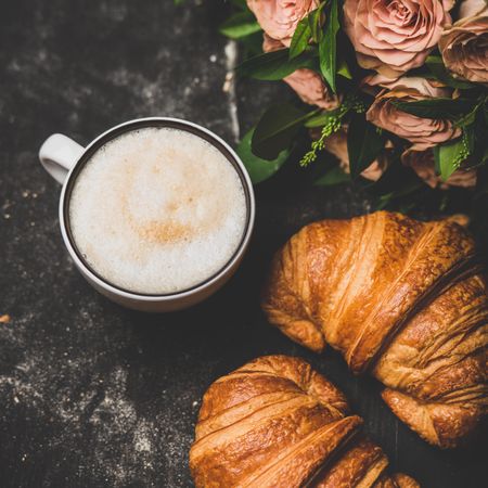 Coffee with croissants and pink roses, close up, square crop