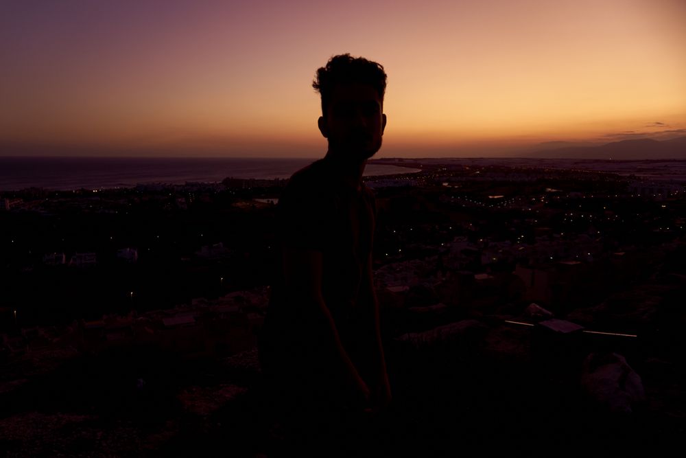 Silhouette of male enjoying picturesque sunset