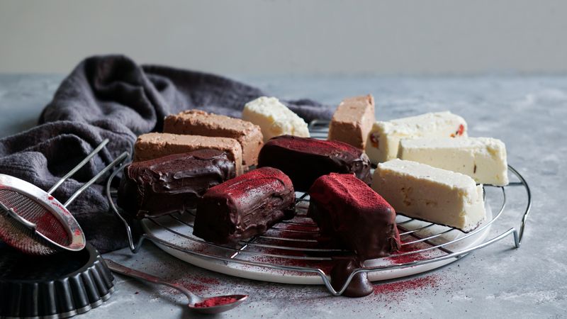 Chocolate and strawberry cakes near bows with ingredients