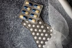 Top view of different pills and medical mesh with copy space